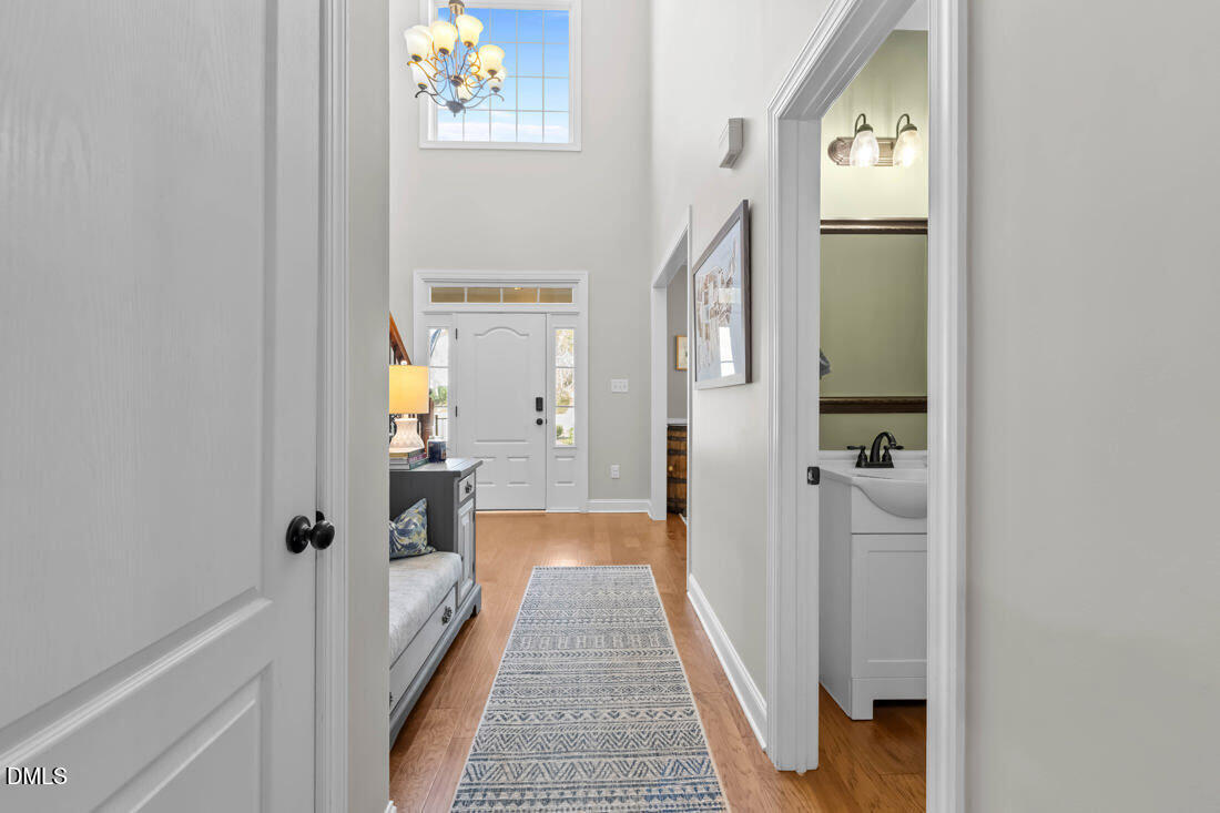 170 Valley Pines Circle Spring Lake, NC 28390 - Photo 17 of 55 a view of a hallway with wooden floor and a bathroom