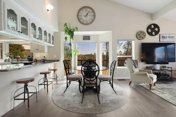 a living room with furniture a clock and a fireplace