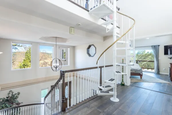 a view of entryway and hall with wooden floor