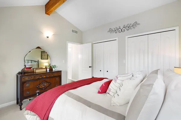 a bedroom with a bed and a dresser
