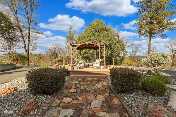a view of a balcony with wooden floor and a swing