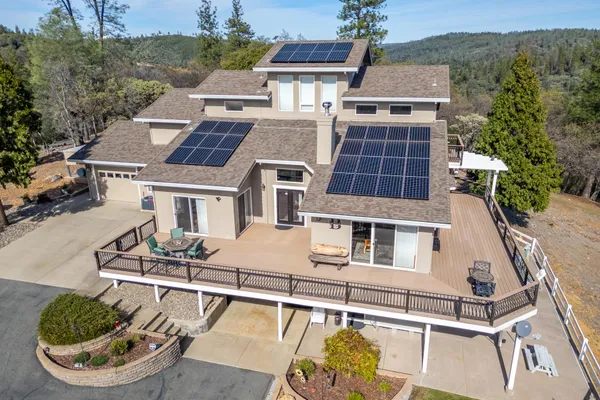 an aerial view of a house with a yard