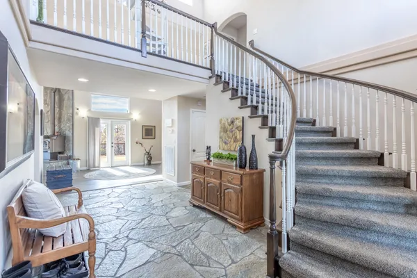 a view of entryway and hall with wooden floor