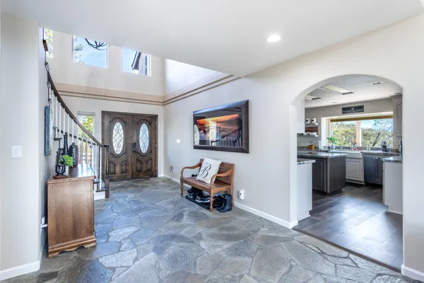 a living room with furniture and a mirror
