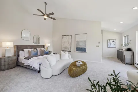 a spacious bedroom with a balcony a bed and a couch