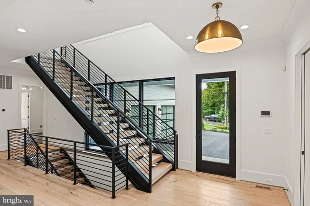 a view of entryway dining room and hall with wooden floor