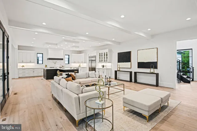 a living room with furniture and view of kitchen