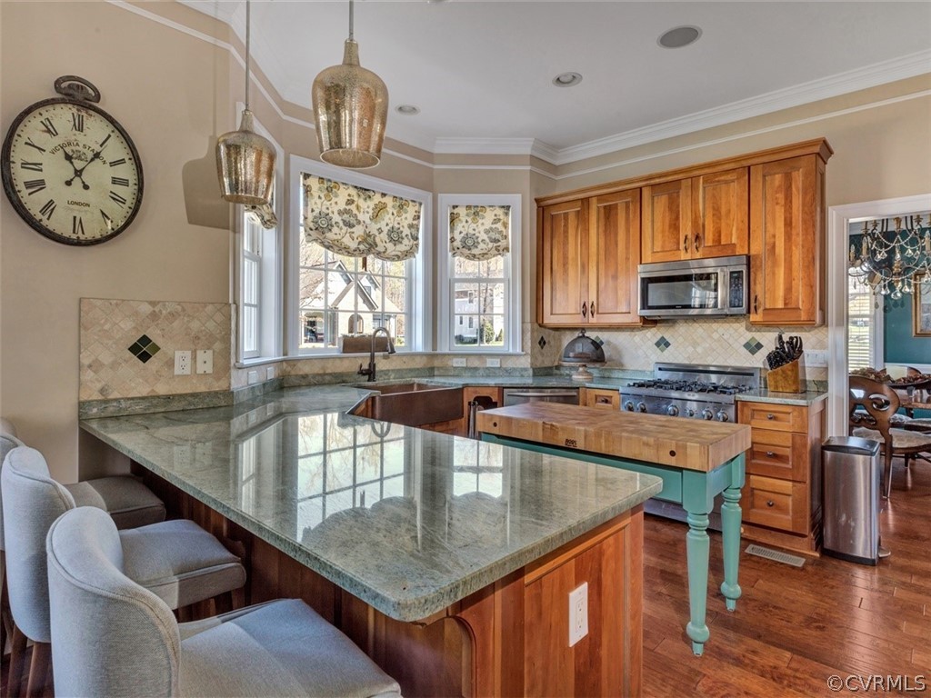 16001 Alsdell Road Midlothian, VA 23112 - Photo 17 of 44 a kitchen with stainless steel appliances granite countertop a table chairs in it and wooden floors