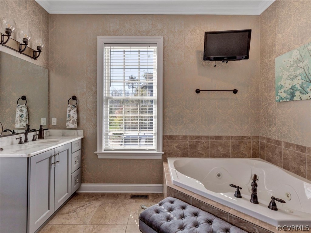 16001 Alsdell Road Midlothian, VA 23112 - Photo 27 of 44 a bathroom with a tub a flat tv screen and a window