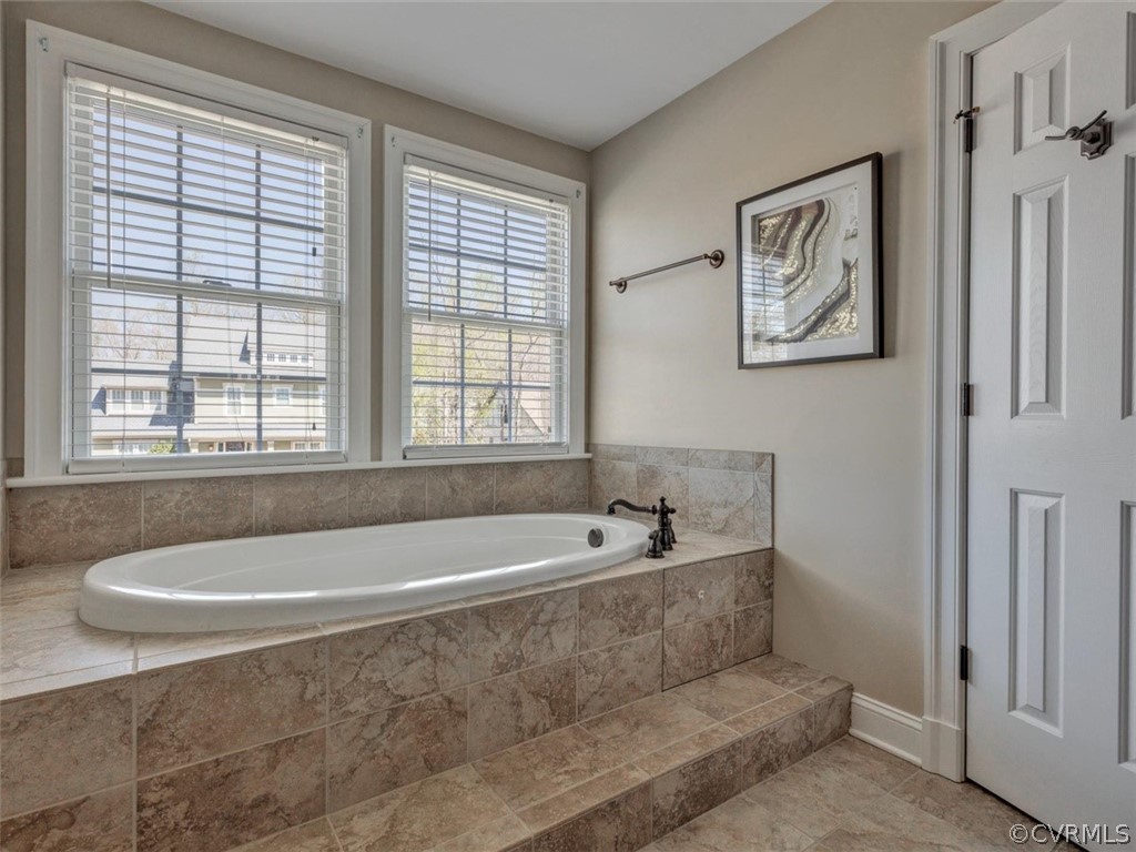 16001 Alsdell Road Midlothian, VA 23112 - Photo 32 of 44 a bath tub sitting in a bathroom next to a window