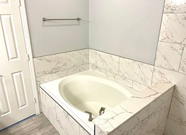 a bathroom with a bathtub and shower