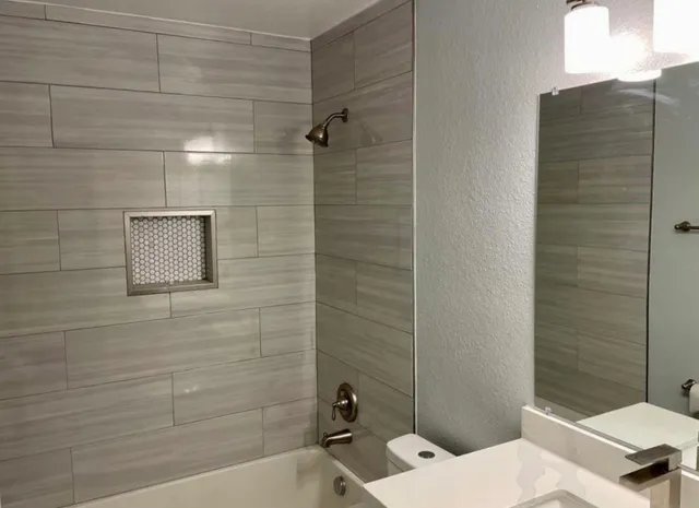 a bathroom with a toilet and shower