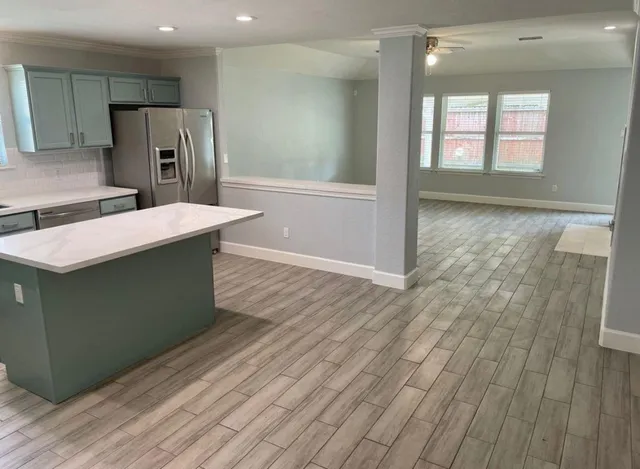 a kitchen with stainless steel appliances granite countertop a sink and a refrigerator