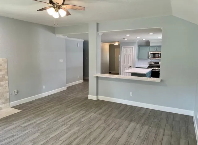 a view of a kitchen with a sink stainless steel appliances and cabinets