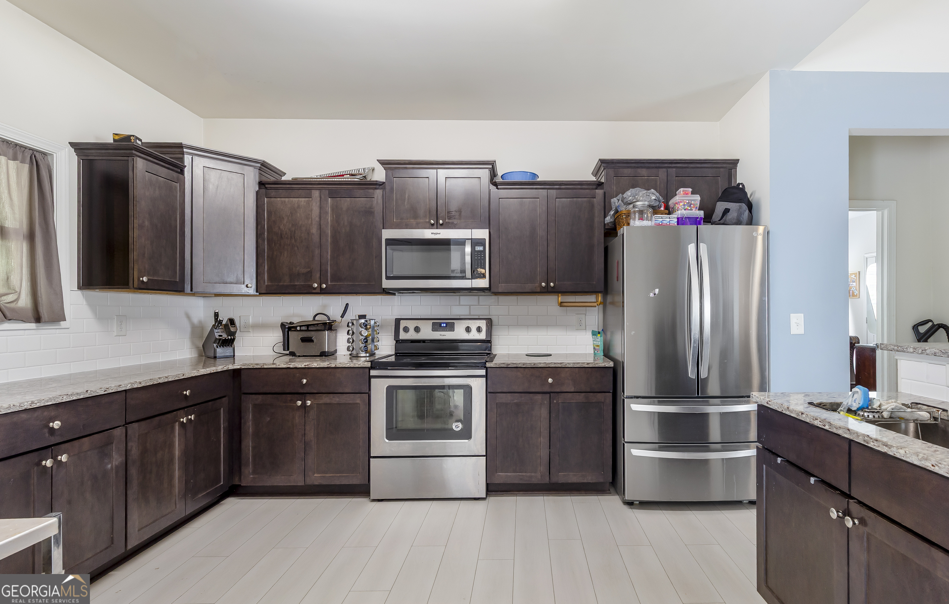 370 Springwater Way Bremen, GA 30110 - Photo 12 of 32 a kitchen with stainless steel appliances granite countertop a refrigerator stove and sink