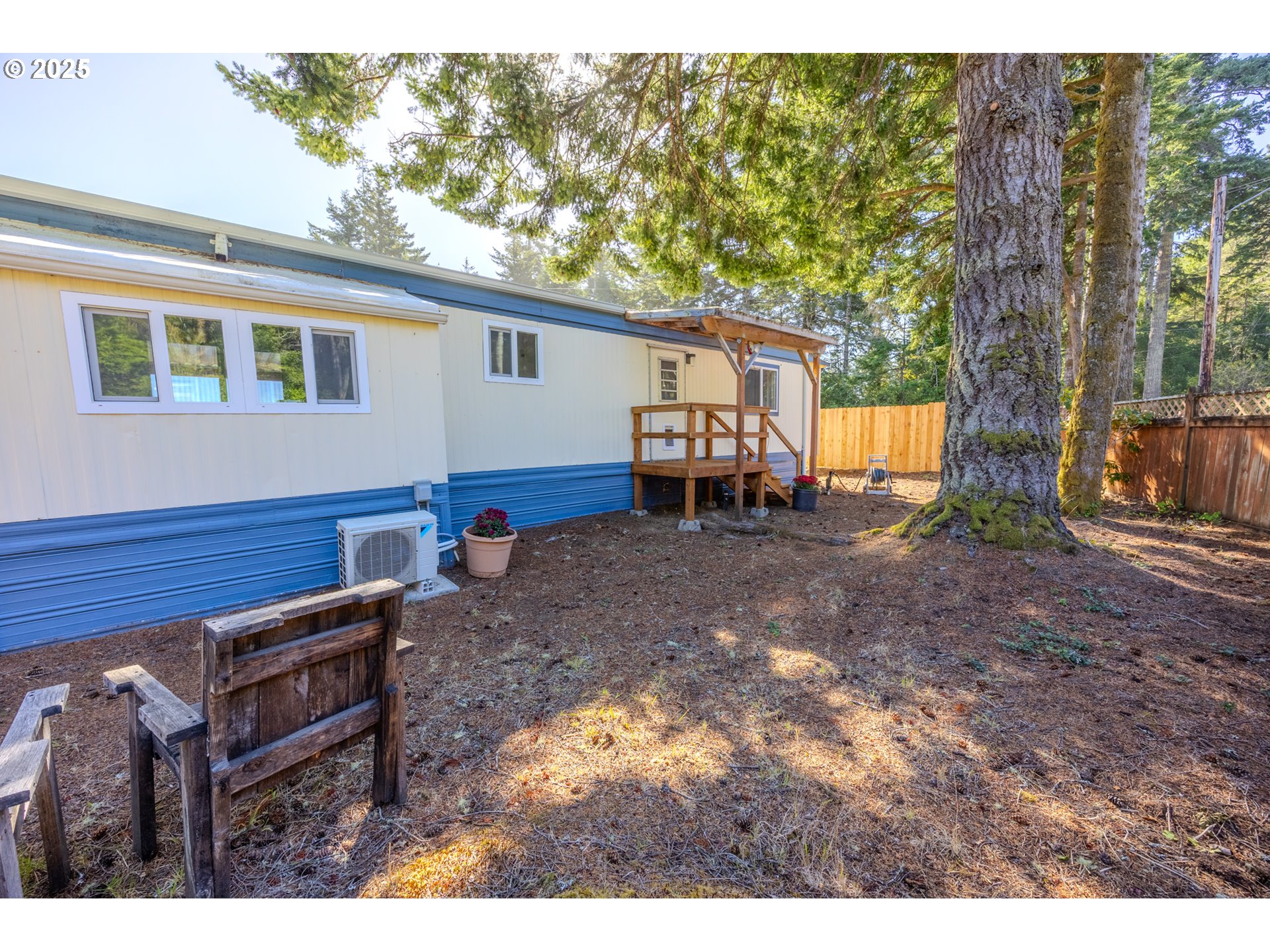 83763 Highway 101, Unit 21 Florence, OR 97439 - Photo 26 of 36 a backyard of a house with barbeque oven and outdoor seating