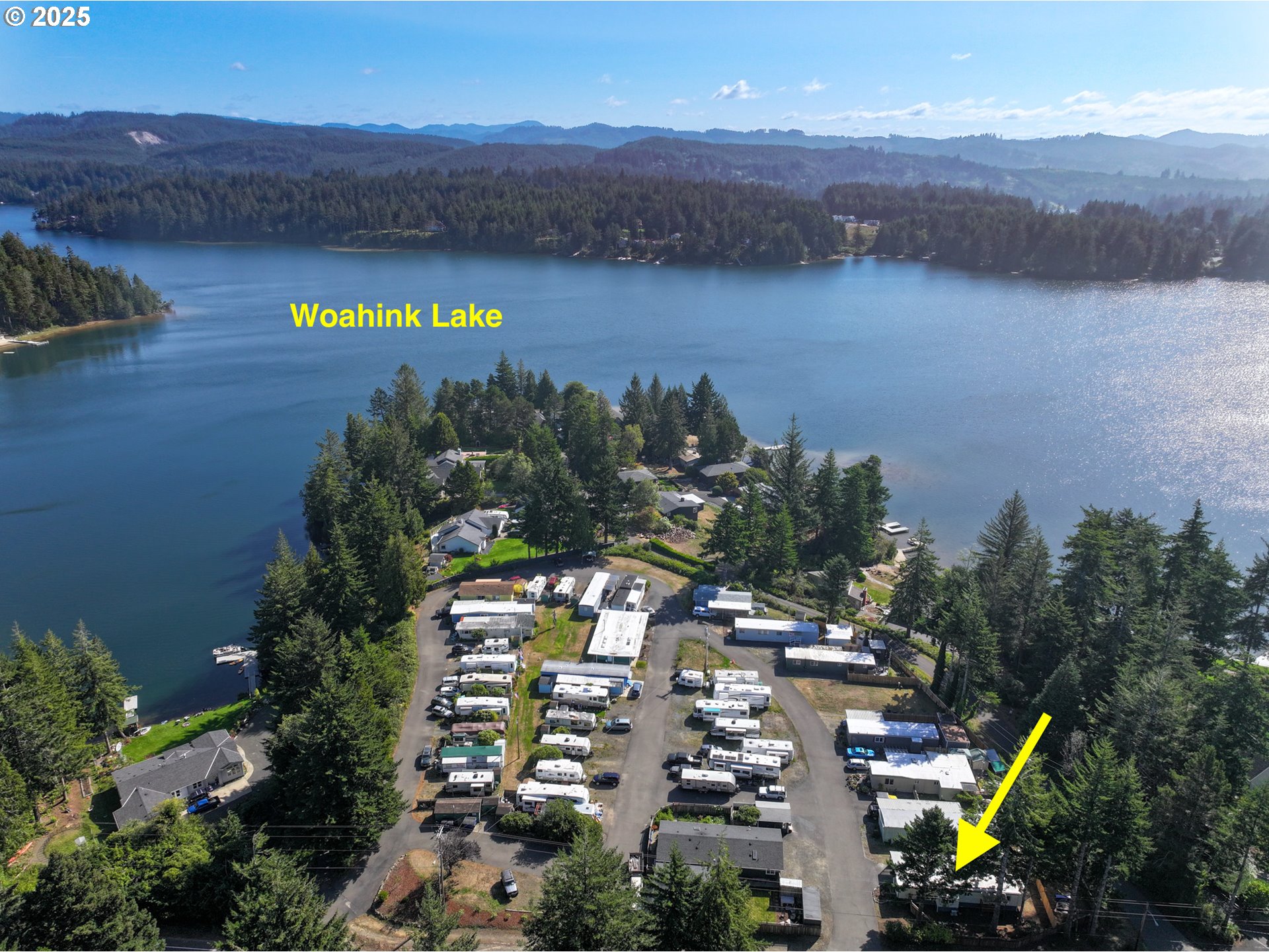 83763 Highway 101, Unit 21 Florence, OR 97439 - Photo 3 of 36 a view of a lake with a mountain in the background