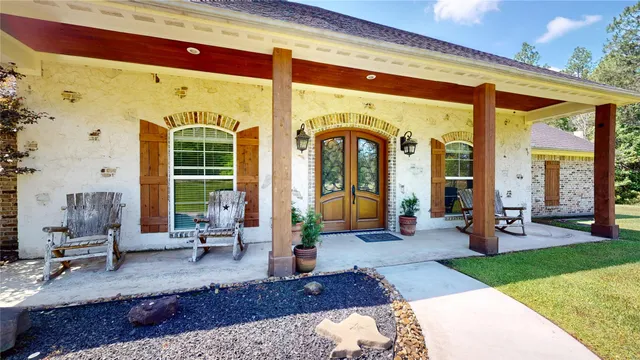 a living room with furniture bathtub and large windows
