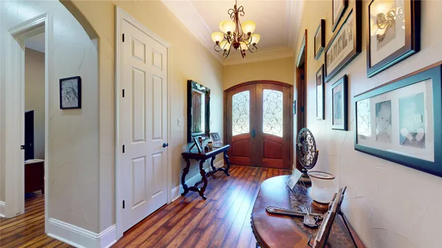 a view of a livingroom with furniture windows wooden floor and a chandelier