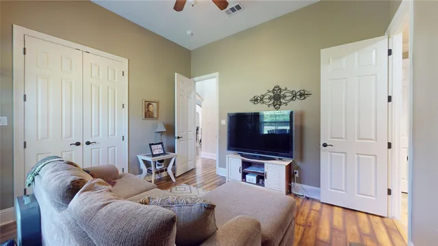 a living room with furniture a flat screen tv and a window