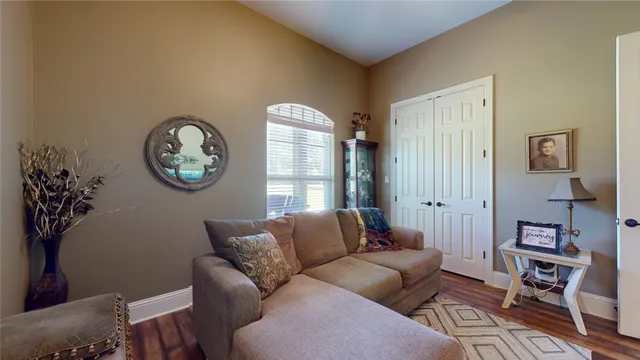 a living room with furniture a rug and a window