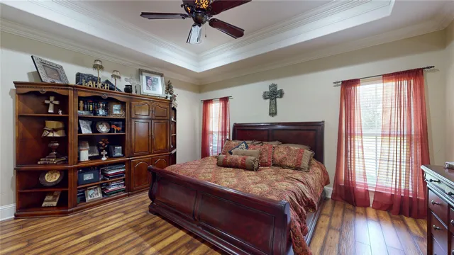 a bed sitting in a bedroom next to a book shelf