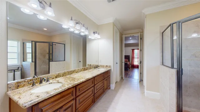 a bathroom with a sink double vanity and a shower