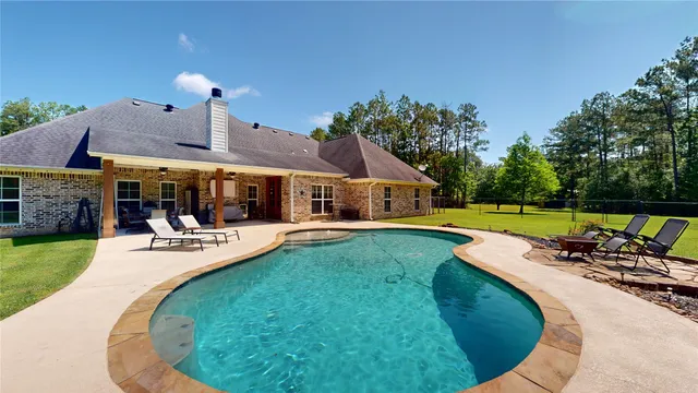 a view of a swimming pool with lounge chairs