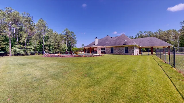 a front view of house with swimming pool and yard