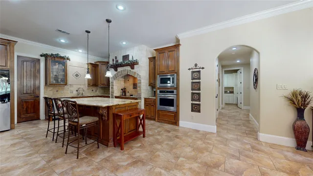 a large kitchen with a table and chairs