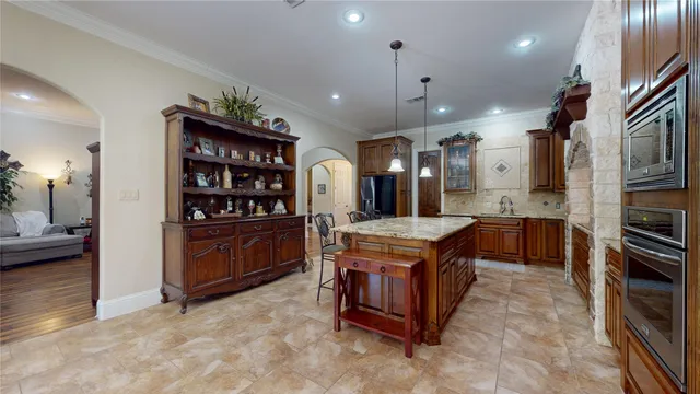 a kitchen with stainless steel appliances granite countertop a stove and a refrigerator