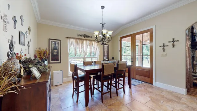 a view of a dining room with furniture and chandelier
