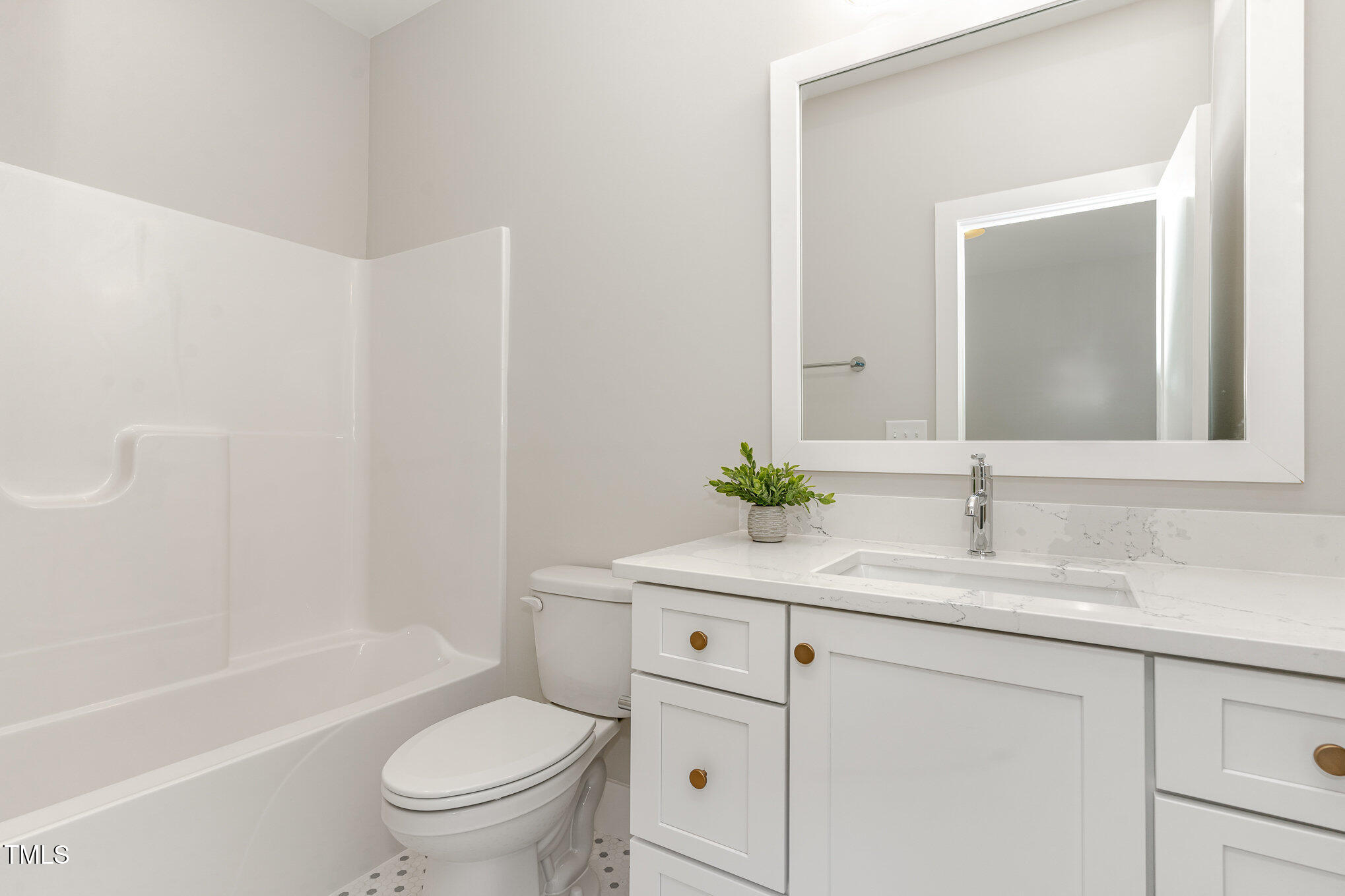 57 Nottoway Lane Wendell, NC 27591 - Photo 11 of 42 a bathroom with a granite countertop sink toilet a large mirror a bathtub and shower