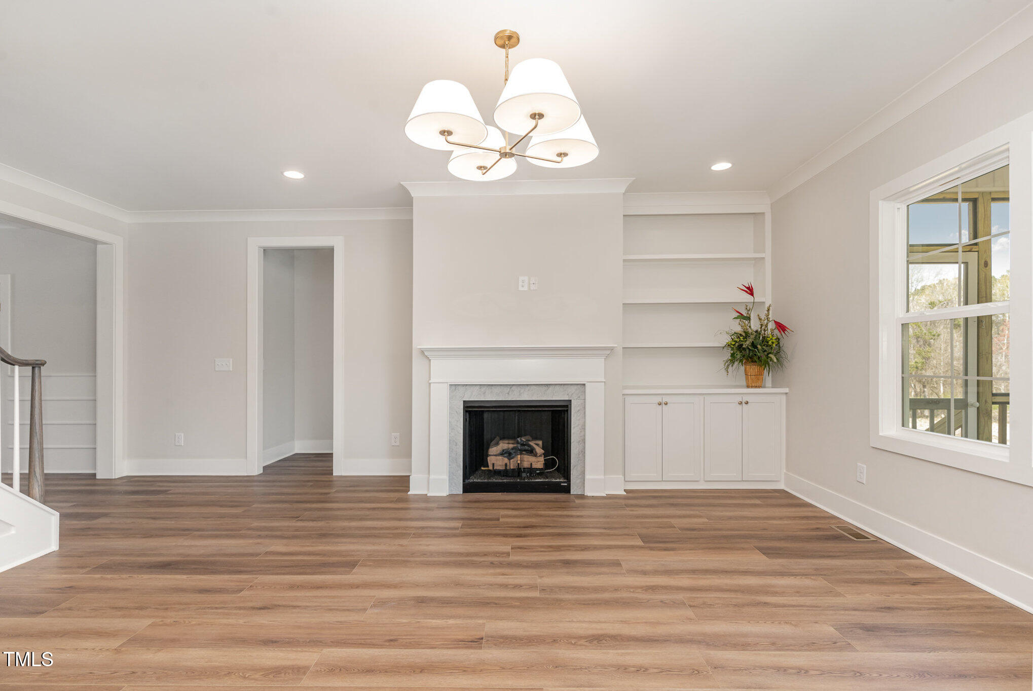 57 Nottoway Lane Wendell, NC 27591 - Photo 13 of 42 a view of an empty room with wooden floor fireplace and a window