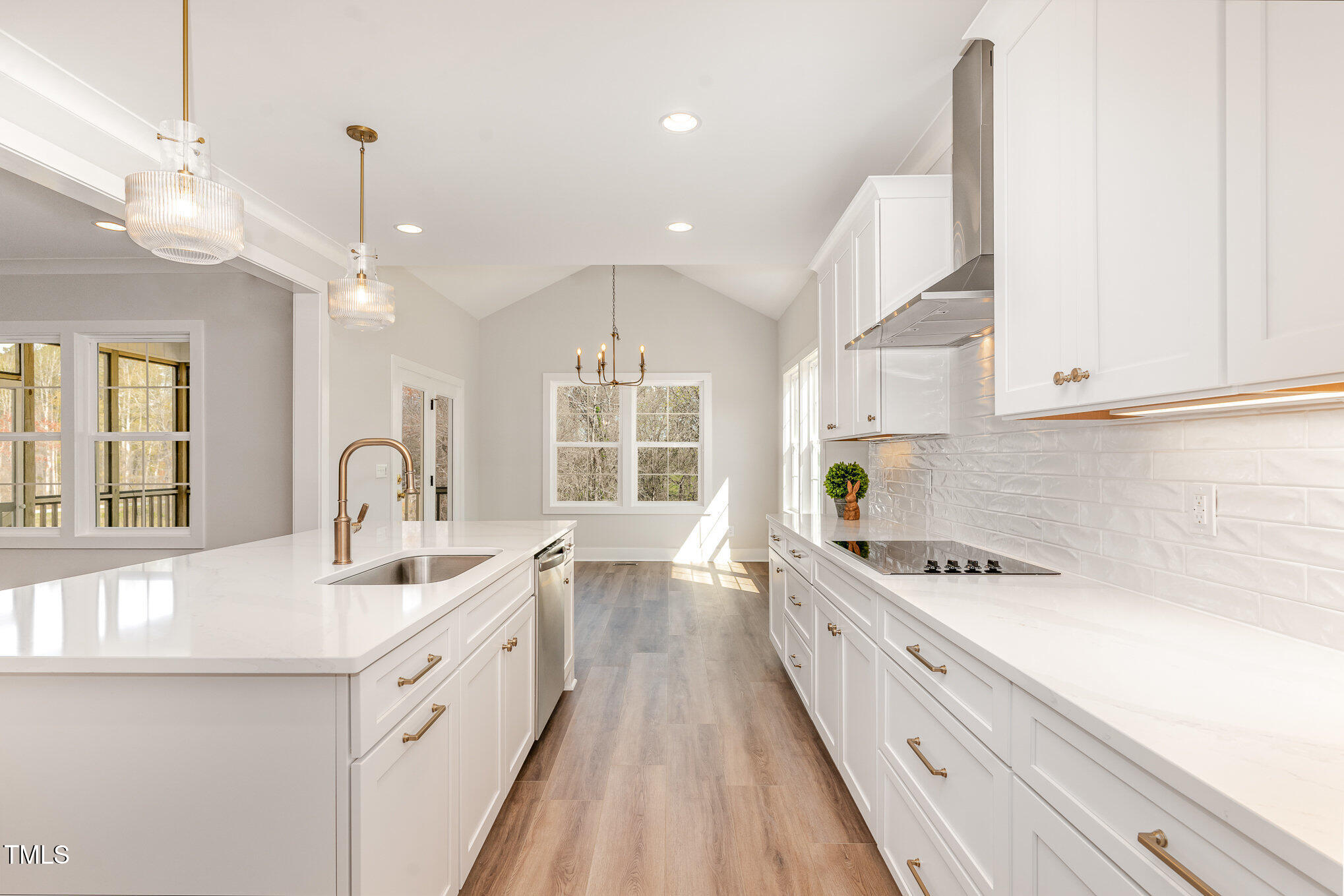 57 Nottoway Lane Wendell, NC 27591 - Photo 19 of 42 a large white kitchen with stainless steel appliances granite countertop a lot of counter space and wooden floors
