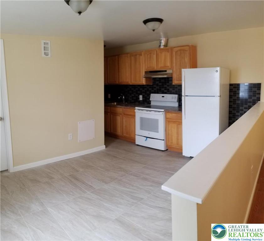 102 East Susquehanna Street, Unit 2 Allentown, PA 18103 - Photo 6 of 10 a kitchen with stainless steel appliances a refrigerator and a stove top oven