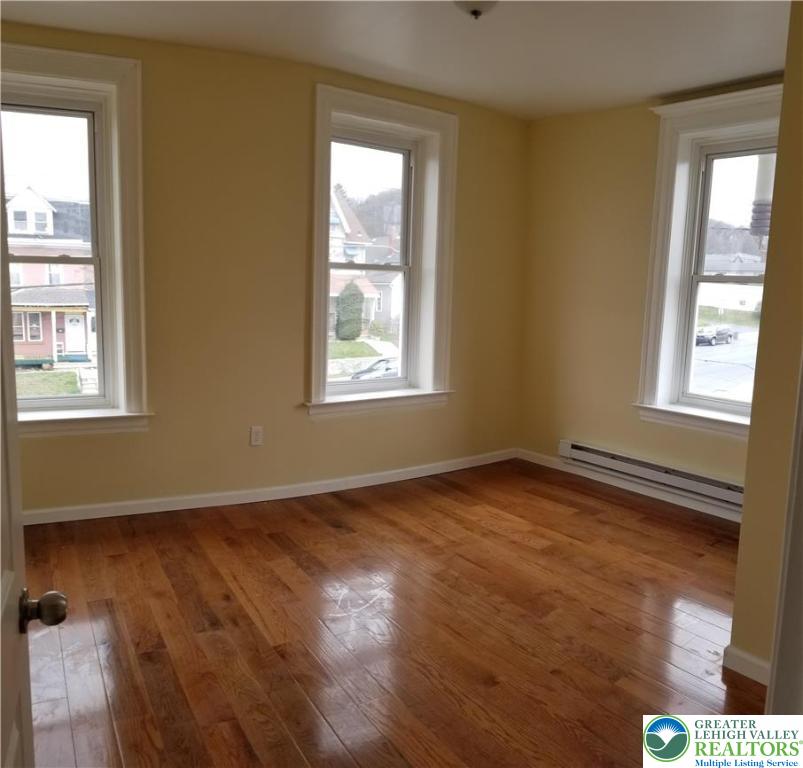 102 East Susquehanna Street, Unit 2 Allentown, PA 18103 - Photo 9 of 10 an empty room with wooden floor and windows