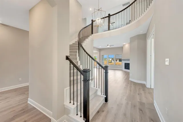 a view of a hallway with wooden floor and staircase