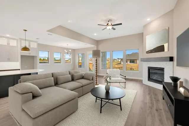 a view of a kitchen with a dishwasher a kitchen island wooden floor and a window