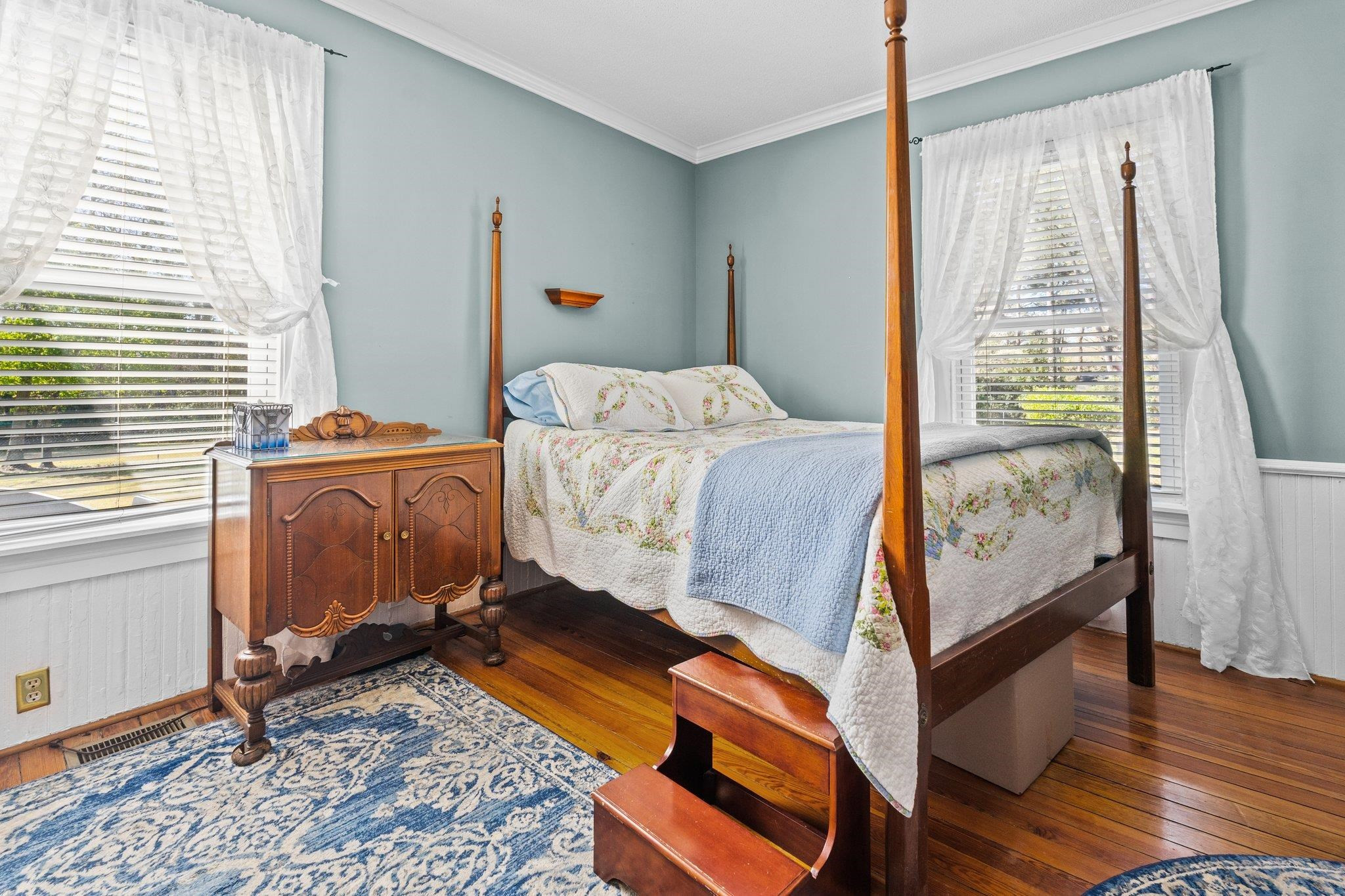 407 Old Post Road Erwin, NC 28339 - Photo 16 of 44 a bedroom with a bed and wooden floor