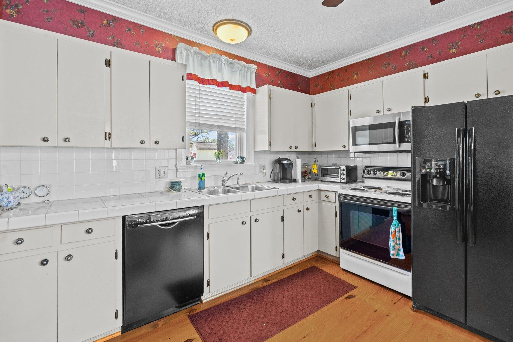 407 Old Post Road Erwin, NC 28339 - Photo 4 of 44 a kitchen with stainless steel appliances granite countertop a stove a sink and a refrigerator