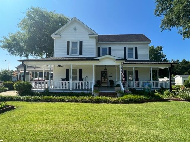 407 Old Post Road Erwin, NC 28339 - Photo 43 of 44 a front view of a house with a yard porch and outdoor seating