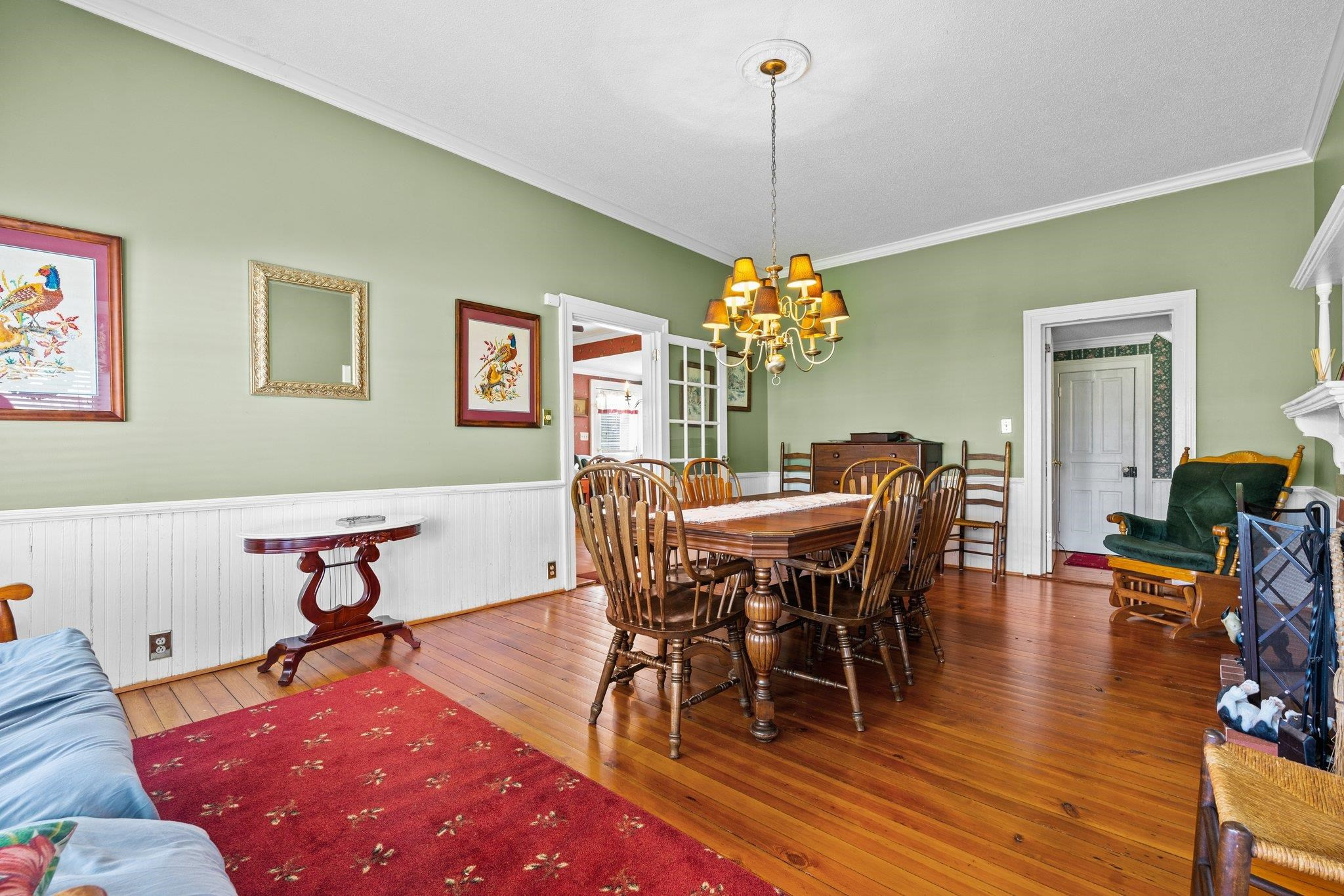 407 Old Post Road Erwin, NC 28339 - Photo 9 of 44 a dining room with furniture a chandelier and wooden floor