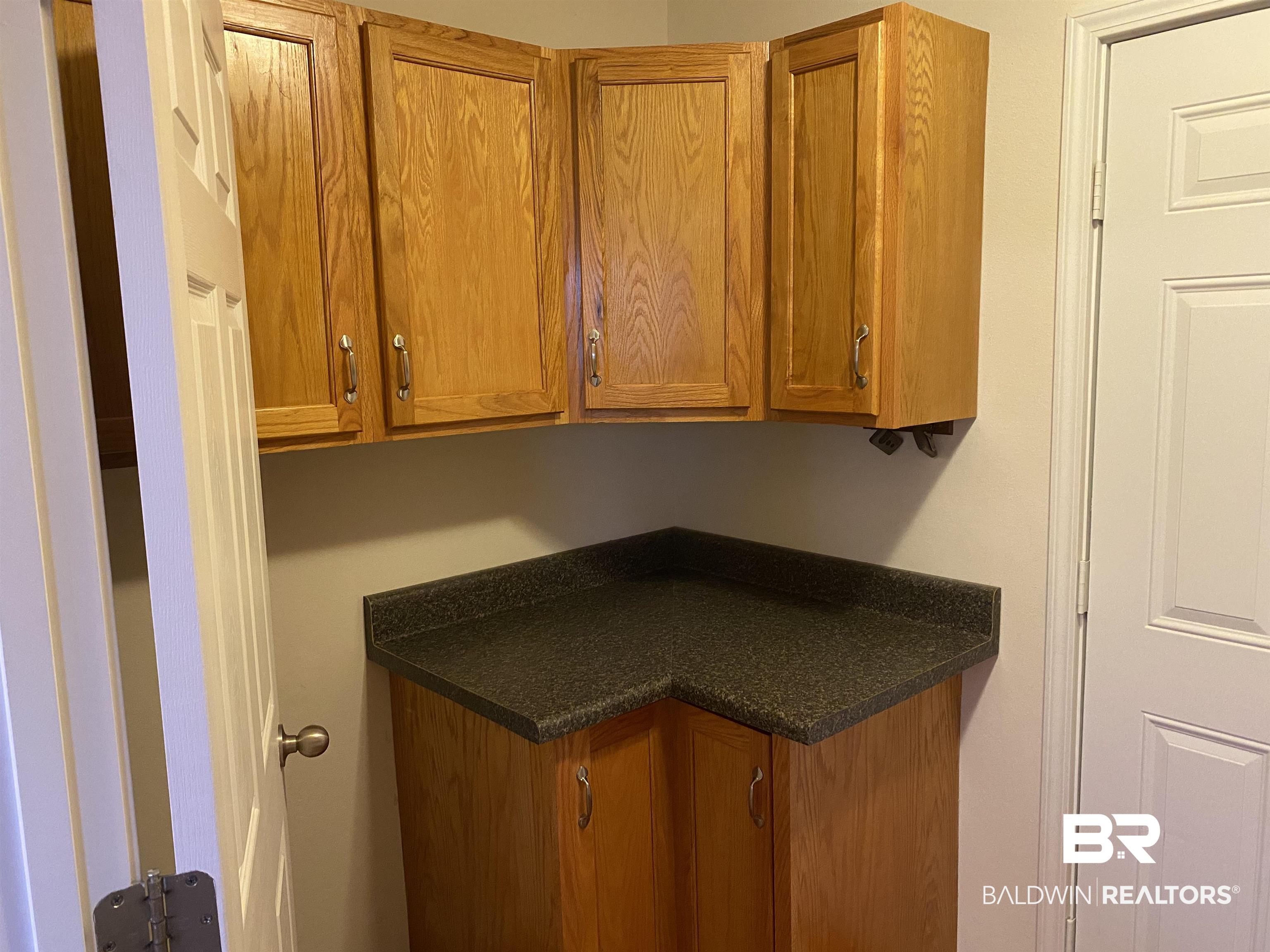 7742 Avery Lane Daphne, AL 36526 - Photo 30 of 41 Laundry Room and Cabinets