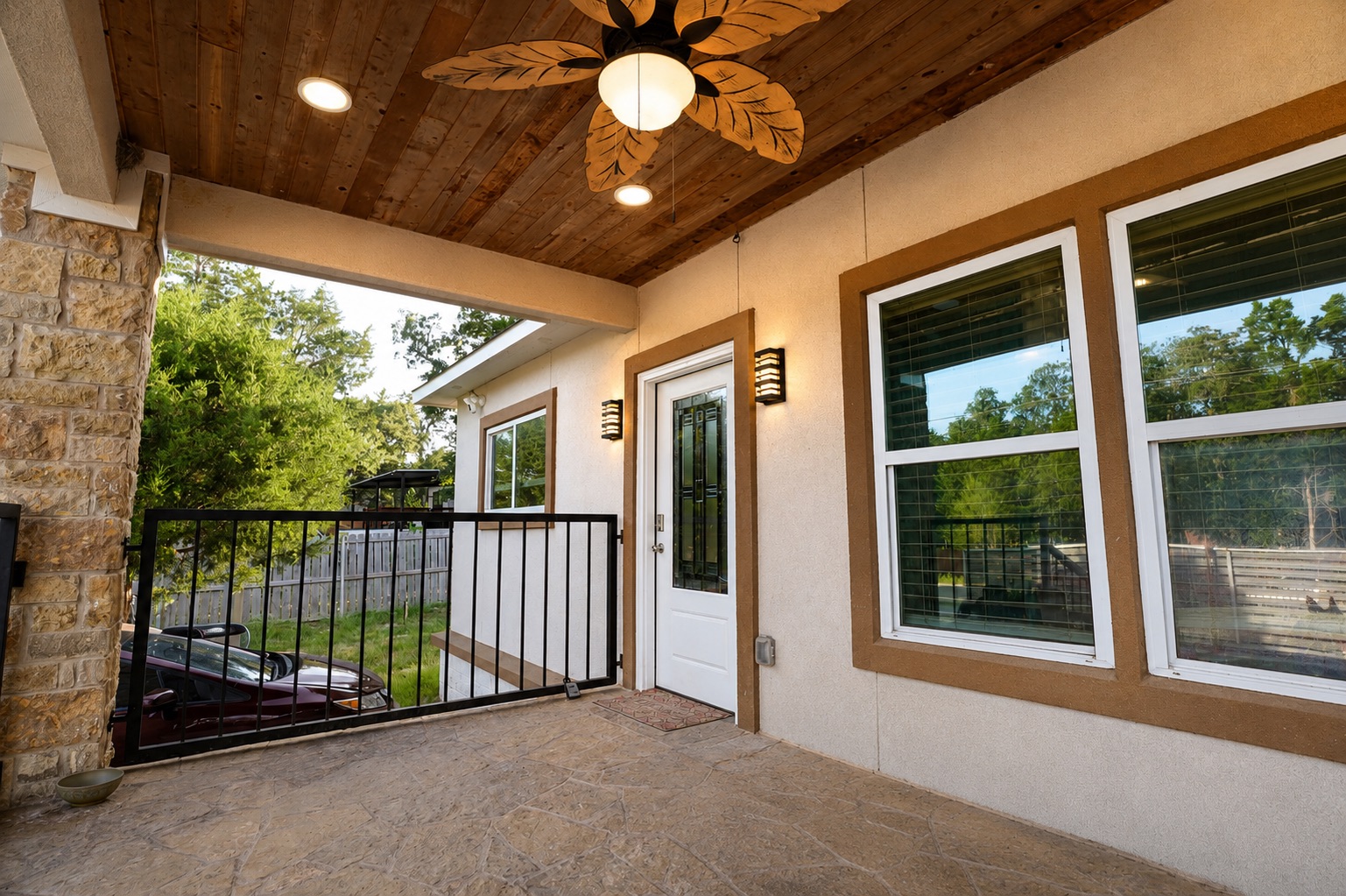 130 Los Arcos Road Elgin, TX 78621 - Photo 5 of 39 An inviting covered patio features a wood-planked ceiling, a decorative ceiling fan, and ample space for outdoor living.