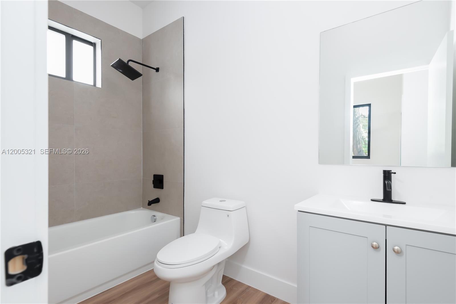 4517 Northwest 3rd Street, Unit 4517 Miami, FL 33126 - Photo 12 of 12 a bathroom with a sink toilet and shower