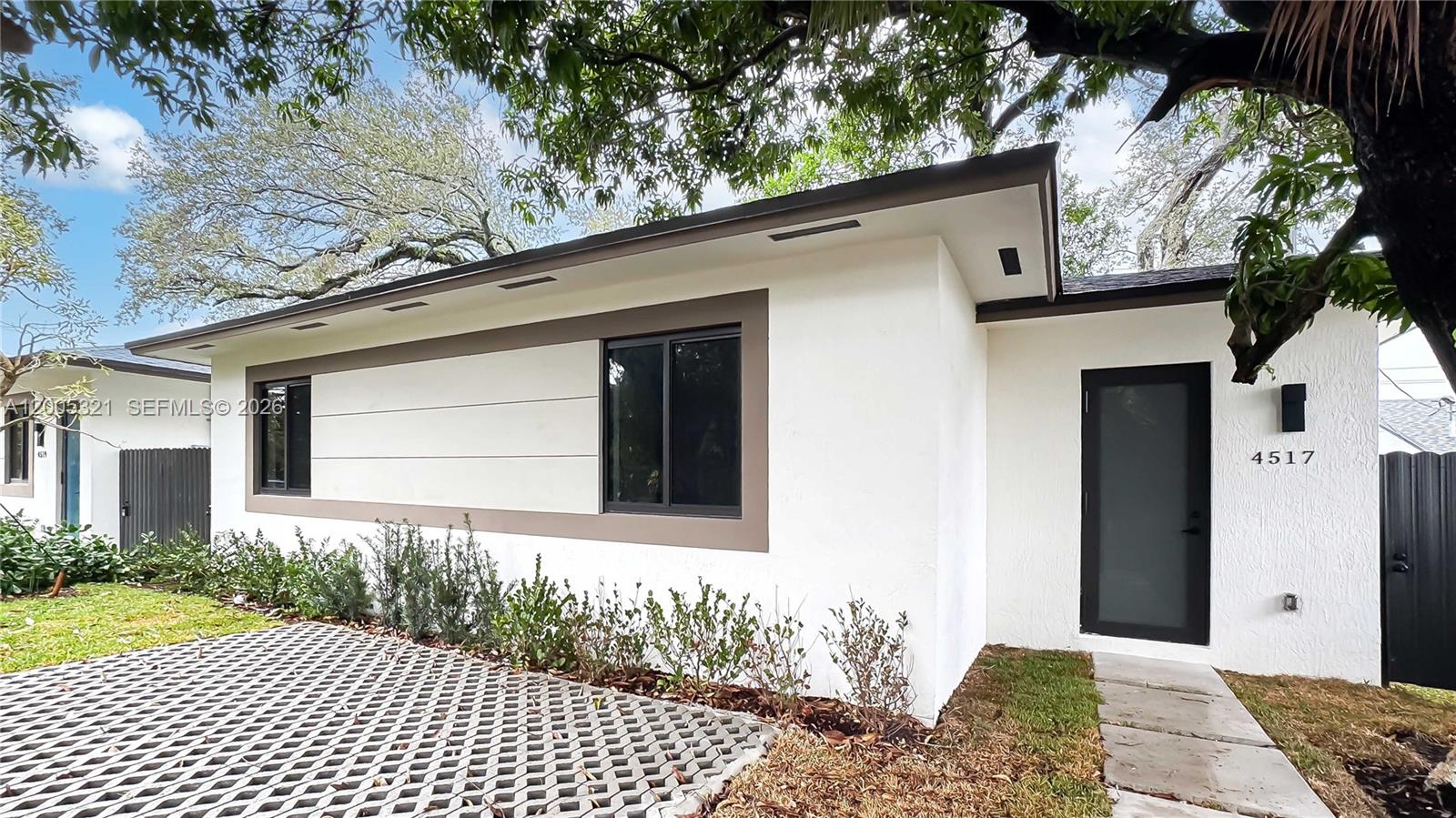 4517 Northwest 3rd Street, Unit 4517 Miami, FL 33126 - Photo 2 of 12 a front view of a house with a yard