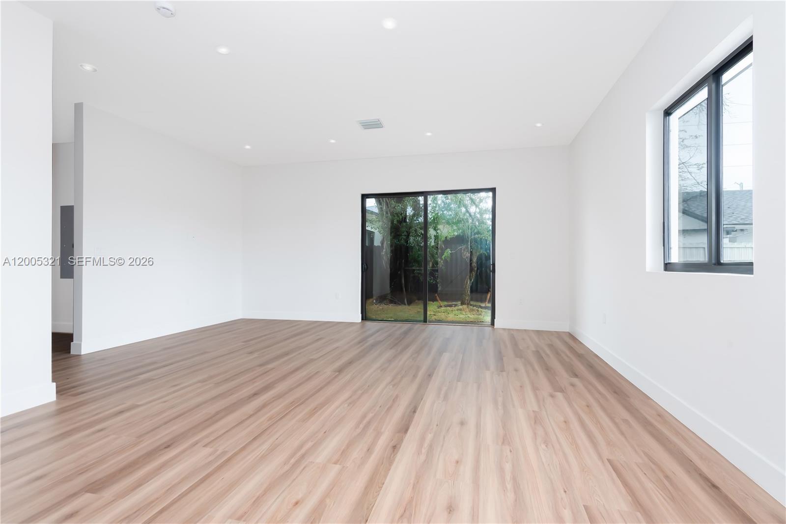 4517 Northwest 3rd Street, Unit 4517 Miami, FL 33126 - Photo 6 of 12 wooden floor in an empty room with a window