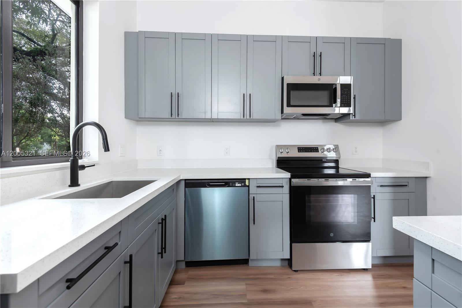 4517 Northwest 3rd Street, Unit 4517 Miami, FL 33126 - Photo 10 of 12 a kitchen with a sink and steel appliances
