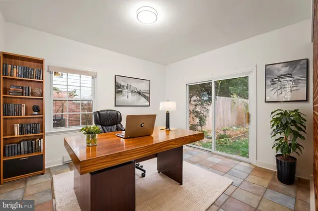 a view of a workspace with furniture and a potted plant
